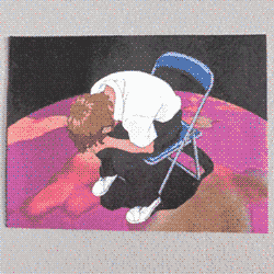 butch with afro-textured hair hunched over clasped hands in metal chair