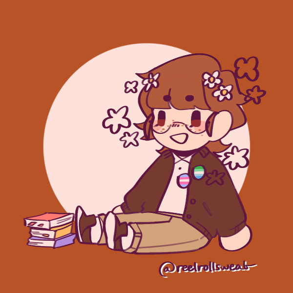 open-mouth smiling boy with flowers in hair wearing trans and gay male pride pins sitting next to pile of books on ground