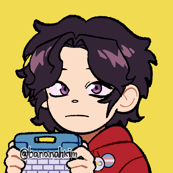 awkward boy holding AAC device wearing neurodivergent and transgender pride pins